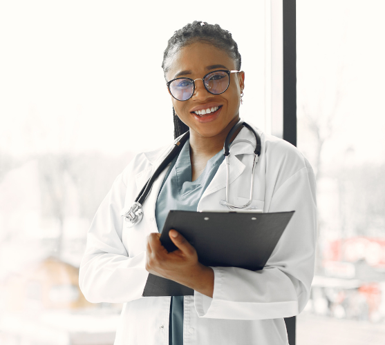 A smiling Greens Health nurse holding a clipboard
